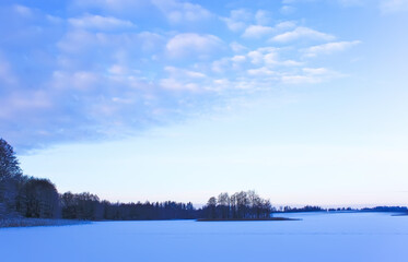 Frozen lake and forest. Winter landscape. 