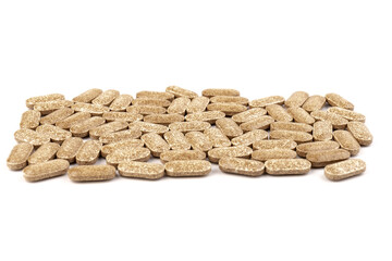 Nutrition supplements, brown vitamin pills on white background.