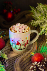 Christmas-inspired scene with a creamy drink in a reindeer-designed mug, flanked by cinnamon sticks, delicate flowers, and a cheerful teddy bear by a window.