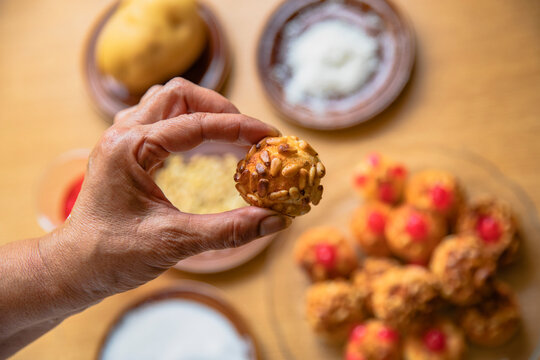 Woman holding sweet food in kitchen