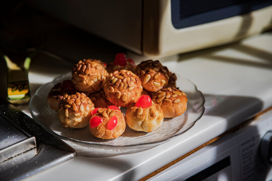 Fresh panellets on plate by oven at kitchen counter