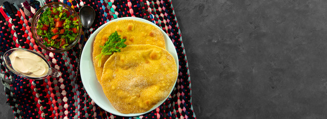 Homemade corn flatbread cilantro green tomato salsa authentic textile Banner Handmade mexican tortilla vegetable.Traditional Indian Punjabi Makki ki roti bread plate top view Wheat flour dough cuisine