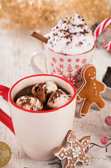 Cup of hot chocolate or cocoa with marshmallow on a wooden background