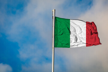 A Flag of Italy flying on a Flagpole against the Sky