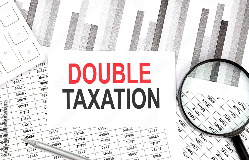 Poster ouble taxation text on paper with calculator,magnifier ,pen on the graph background
