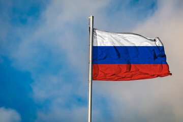 A Flag of Russia flying on a Flagpole against the Sky