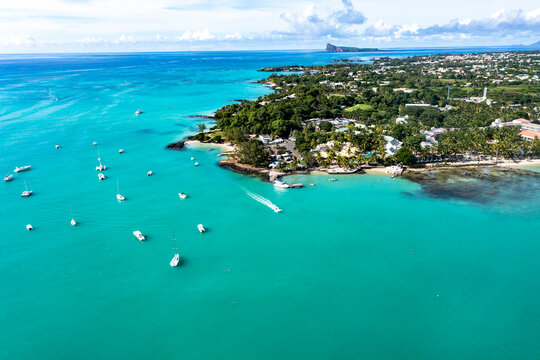 Mauritius, Pamplemousses, Grand-Baie, Helicopter view of turquoise waters of Indian Ocean and coastal town in summer