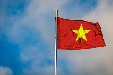 A Flag of Vietnam flying on a Flagpole against the Sky