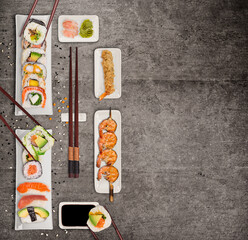 Top view of assorted mixed Japanese sushi set,black concrete background.