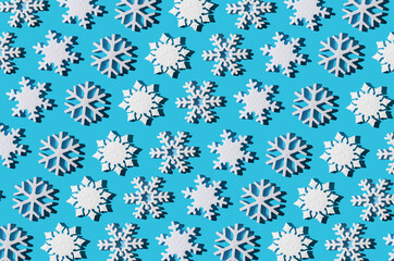 Christmas background. Snowflake pattern. White snowflakes on blue. Snow. Winter mood. Conceptual abstraction. Styrofoam snowflake. New Year's pattern. Copy space.