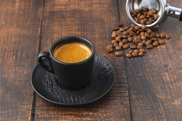 Fresh espresso coffee together decorated with coffee beans on wooden table