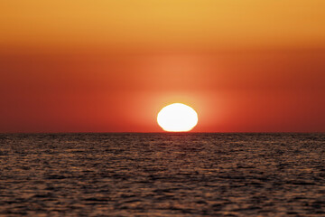 sun at sunrise in the Mediterranean sea on a summer day