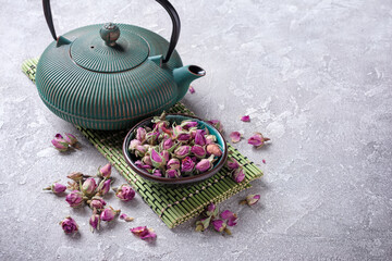Beautiful green japanese cast iron teapot with tea of dry roses