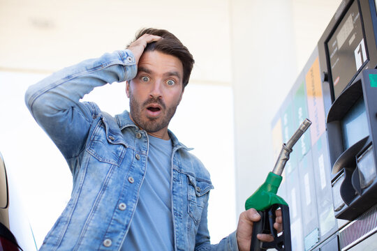 man in gas station is shocked by the fuel prices