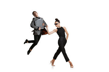 Two stylish office workers in business suits in action isolated on white background. Art, beauty, fashion and business concept