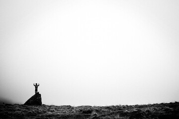 Foggy day on dolomites,  boy plays on the rocks