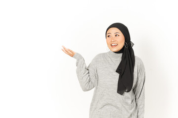 Presenting product on palm of Beautiful Asian Woman Wearing Hijab Isolated On White Background