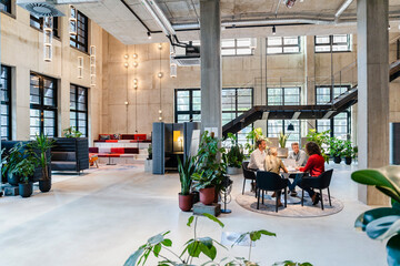 Coworkers attending meeting at office lobby