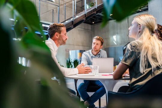 Businessman explaining coworkers in meeting at office