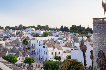 white traditional southern italian trulli village houses with tapered stone roofs