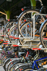 Bicycles multi-storey parking in front of a train station. Alternative transportation. Eco-friendly way to travel in city. Great for the environment.
