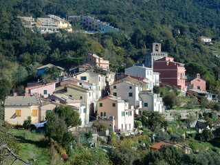 Fototapeta na wymiar the tiny village of Costa di Framura is perched on top of a hill overlooking the blue of the mediterranean sea and can be reached on a hike to appreciate the surrounding nature, Liguria, Italy