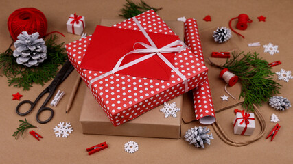 Packing Christmas gifts with red paper