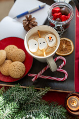 christmas, winter holidays and leisure concept - close up of marshmallow snowman in cup of coffee