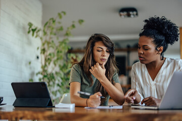 Focused adult women, trying to solve a problem