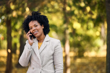 Carefree adult woman, speaking to her partner, on the phone