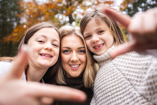 Happy mother daughters selfie portrait in the wood