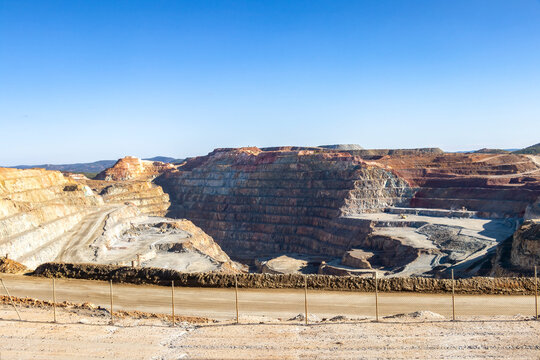 Corta Atalaya with mining levels at open mine pit. Deep excavation of pyrite and extraction of minerals of cooper and gold in municipality of Minas de Riotinto, Huelva, Andalusia, Spain
