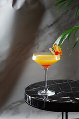citrus and pineapple cocktail on marble table close up. tropical cocktail on shadow background