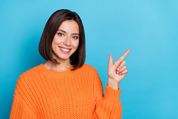 Portrait of attractive cheerful girl demonstrating copy empty space ad advert isolated over bright...