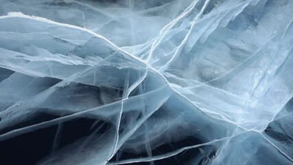 Aerial top down winter frozen blue moody ice of lake Baikal, deep cinematic cracks great depth, transparent ice close-up. Russia nature landscape from above. Siberia natural wonder. Travel tourism. 4k - Powered by Adobe