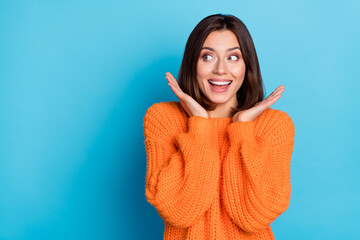 Portrait of attractive amazed cheerful girl looking aside copy space news isolated over bright blue color background