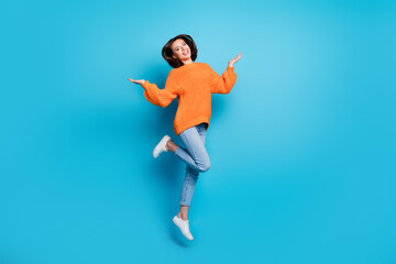 Fototapeta na wymiar Full length body size view of attractive cheerful girl jumping having fun rest isolated over bright blue color background