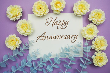 Happy Anniversary typography text and flower decorate on purple background