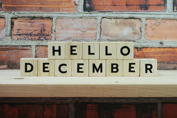 Hello December alphabet letter on shelves wooden background