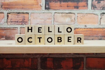 Fototapeta premium Hello October alphabet letter on shelves wooden background