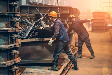 Metallurgical plant workers in process of work, industrial interior.