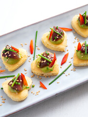 Tuna blinis with avocado. Traditional canape for Christmas.