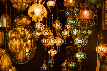 Assortment of lanterns mosaic lamps and oriental traditional lamps hanging in market Turkey.