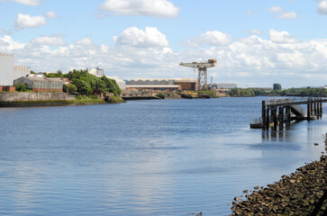 Deserted River View with Industrial Crane in Distance on Sunny Day