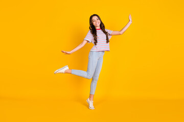 Fototapeta na wymiar Full length photo of young hispanic preteen girl happy positive smile have fun playful isolated over yellow color background