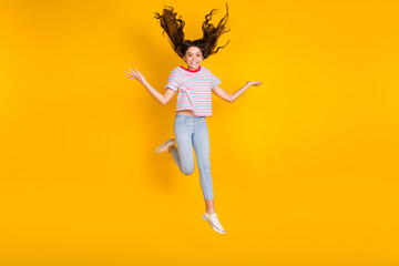 Fototapeta na wymiar Full length photo of young preteen girl happy positive smile have fun jump up isolated over yellow color background