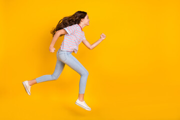 Fototapeta na wymiar Full size profile side photo of young girl jump up go walk run hurry sale look empty space isolated over yellow color background