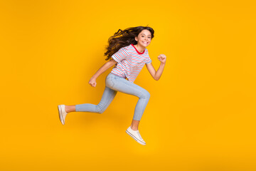 Fototapeta na wymiar Full body profile side photo of preteen girl happy smile go walk run hurry jump isolated over yellow color background