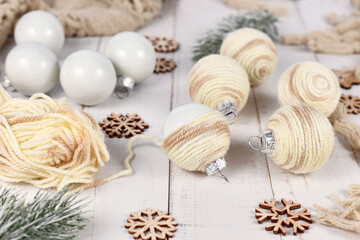 Fototapeta na wymiar Do it yourself boho style Christmas bauble ornaments with with cream colored cord