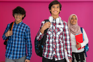 A group of Arab teenagers, a student team walking forward into the future and back to school the concept of a pink background. The concept of successful education for young people. Selective focus